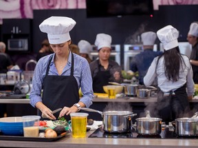 Employees at Air Canada taking part in a special event to prepare recipes for a special employee cookbook, prior to the pandemic. SUPPLIED