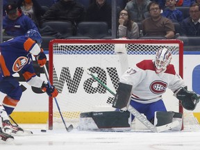 Canadiens goaltender Andrew Hammond stops a scoring chance from Anders Lee of the New York Islanders at UBS Arena on Sunday, Feb. 20, 2022 in Elmont, N.Y.