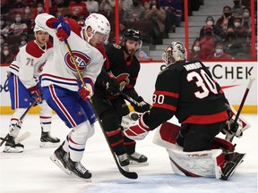 Canadiens' Artturi Lehkonen (62) controls a bouncing puck to score on Senators goaltender Matt Murray during first period NHL hockey action in Ottawa on Saturday, Feb. 26, 2022.