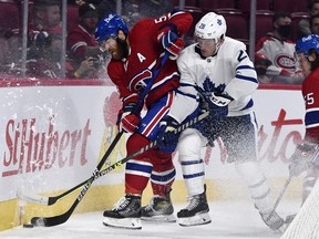 Canadiens defenceman David Savard (58) takes the puck away from Toronto Maple Leafs forward Ondrej Kase (28) at the Bell Centre on Sept. 27, 2021.