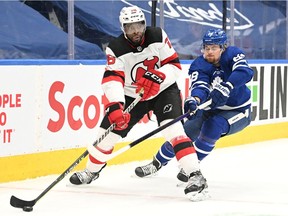 New Jersey Devils forward P.K. Subban clears the puck away from Toronto Maple Leafs forward William Nylander during first period at Scotiabank Arena in Toronto on Jan. 31, 2022.