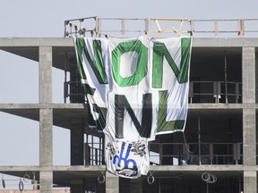 A Greenpeace banner hangs from a building under construction on the site of the MIL campus of the Université de Montréal in October 2020.