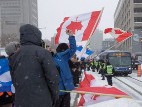 Protesters line the road near the National Assembly in Quebec City on Saturday, Feb.  19, 2022.