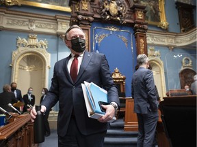 Quebec Premier François Legault walks in for question period Tuesday, Feb. 22, 2022 at the legislature in Quebec City.