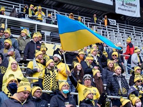 Columbus Crew fan waves the flag of Ukraine during warm-ups before the game against the Vancouver Whitecaps at Lower.com Field on Saturday, Feb. 26, 2022, in Columbus, Ohio.