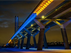 The Champlain Bridge was lit up in blue and yellow in Brossard on Saturday February 26, 2022 in support of Ukraine.