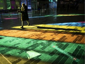 People pass through a rainbow of colours as they go through the vaccination centre at Palais des Congrès in January.