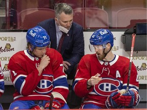 Canadiens interim head coach Martin St. Louis has a conversation with Jake Evans, left, and Paul Byron during a game last month at the Bell Centre.