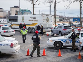 Sûreté du Québec and Laval police at the scene where 50 year-old Lorenzo Giordano, who had ties to the Rizzuto organized crime family, was shot in a vehicle in the parking lot of the Carrefour Multisports in Laval on Tuesday, March 1, 2016.