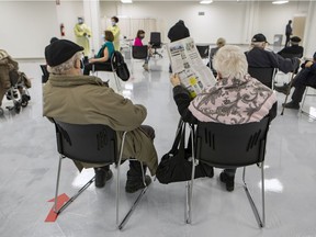 Senior citizens sit in the waiting area after receiving their COVID-19 vaccinations at Decarie Square in Montreal on Monday, March 1, 2021.