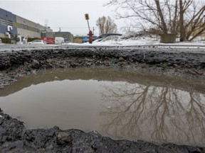 A pothole is half full of water on 54th Ave. in the Lachine, March 7, 2022.