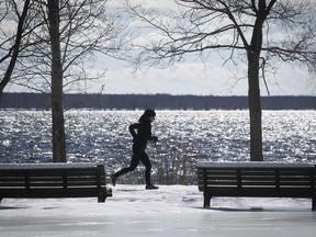 A lone runner makers his way along the frozen paths at Summerlea Park in Lachine on Tuesday March 8, 2022.