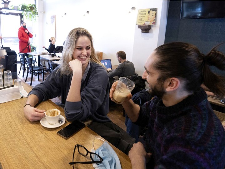  Claudia Nicole and Micah Milton, who both work in the restaurant industry, enjoy a coffee at Lili and Oli café in Montreal on Saturday, March 12, 2022.
