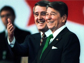Prime Minister Brian Mulroney introduces U.S. President Ronald Reagan during a welcoming ceremony at the Quebec City airport on March 17, 1985.