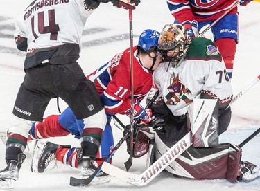 Montreal Canadiens right wing Brendan Gallagher (11) is driven into the shoulder of Arizona Coyotes goaltender Karel Vejmelka (70) during 2nd period NHL action at the Bell Centre in Montreal on Tuesday, March 15, 2022.