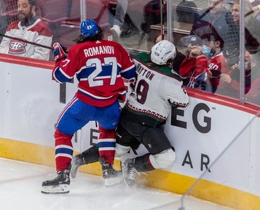 Montreal Canadiens defenseman Alexander Romanov (27) checks Arizona Coyotes centre Barrett Hayton (29) into the boards during 3rd period NHL action at the Bell Centre in Montreal on Tuesday, March 15, 2022.