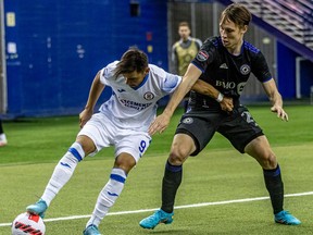 CF Montréal midfielder Lassi Lappalainen and Cruz Azul forward Milton Caraglio battle for the ball in the corner at the Olympic Stadium in Montreal on March 16, 2022.