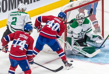Montreal Canadiens right wing Joel Armia (40) got a stick in the face after Dallas Stars defenseman Jani Hakanpaa (2) lifted it in front of Dallas Stars goaltender Jake Oettinger (29) during 1st period NHL action at the Bell Centre in Montreal on Thursday, March 17, 2022.