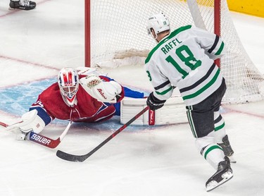 Dallas Stars left wing Michael Raffl (18) is stopped point blank by the glove hand of Montreal Canadiens goaltender Jake Allen (34) during 1st period NHL action at the Bell Centre in Montreal on Thursday, March 17, 2022.