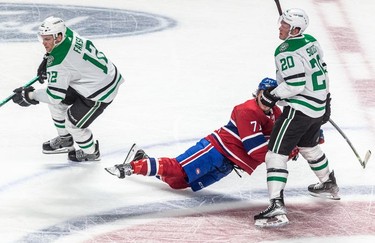 Montreal Canadiens centre Jake Evans (71) is knocked to the ice by Dallas Stars defenseman Ryan Suter (20) during 1st period NHL action at the Bell Centre in Montreal on Thursday March 17, 2022.