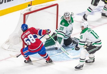 Montreal Canadiens centre Mike Hoffman (68) couldn't put the puck past Dallas Stars goaltender Jake Oettinger (29) with Dallas Stars centre Joe Pavelski (16) checking from behind during 1st period NHL action at the Bell Centre in Montreal on Thursday, March 17, 2022.
