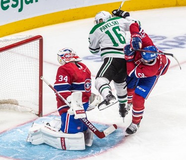 Dallas Stars centreJoe Pavelski (16) squeezes between Montreal Canadiens goaltender Jake Allen (34) and Montreal Canadiens defenseman Jeff Petry (26) during 2nd period NHL action at the Bell Centre in Montreal on Thursday, March 17, 2022.