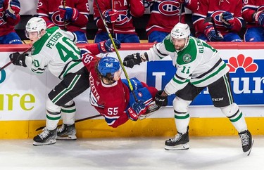 Montreal Canadiens left wing Michael Pezzetta (55) is dumped by Dallas Stars centre Luke Glendening (11) along the boards during 2nd period NHL action at the Bell Centre in Montreal on Thursday, March 17, 2022.