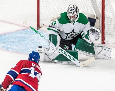 Montreal Canadiens centre Nick Suzuki (14) fires the puck just wide against Dallas Stars goaltender Jake Oettinger (29) during 2nd period NHL action at the Bell Centre in Montreal on Thursday, March 17, 2022.