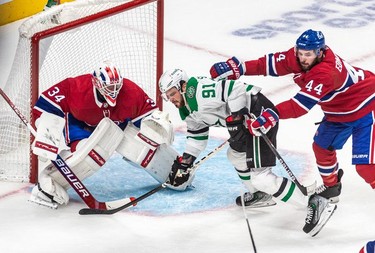 Montreal Canadiens defenseman Joel Edmundson (44) received a cross checking penalty on Dallas Stars centre Tyler Seguin (91) in front of Montreal Canadiens goaltender Jake Allen (34) during 2nd period NHL action at the Bell Centre in Montreal on Thursday, March 17, 2022.