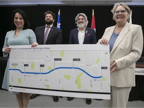 Montreal Mayor Valérie Plante, left, and Quebec Transport Minister Chantal Rouleau, far right, hold the latest map of the Blue Line of the Montreal métro on March 18, 2022, with Canadian Heritage Minister Pablo Rodriguez, right, and STM chairman Éric Alan Caldwell.