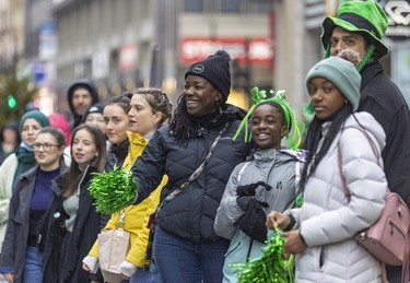 Spectators watch the parade go past during the St. Patrick's parade in Montreal on March 20, 2022.