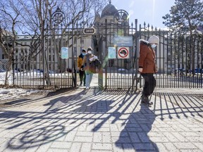 People exit the main gate at Dawson College in Montreal on Tuesday, March 22, 2022.