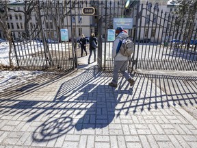 People enter the main gate at Dawson College in Montreal Tuesday March 22, 2022.