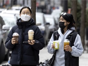 People remained masked as they go about their daily lives, in Montreal, on Wednesday, March 23, 2022.