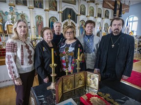 Fr. Gene Ruditch, right, with, from left, Lili Mospan-Hayduk, Valentina Hayduk, Anatoly Hayduk , Olga Katola-Hayduk and Volodymyr Hayduk at the Ukrainian Orthodox Church of St. George in the Lachine borough of Montreal Wednesday March 23, 2022.  The Hayduk family was helped by the church 70 years ago when they came to Canada and now they intend to do the same once Ukrainian refugees start arriving.