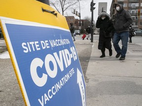People make their way along Hutchinson Street, near the Parc Ave. COVID-19 vaccination clinic on Monday, March 28, 2022.