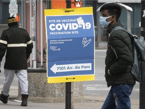 People make their way past a COVID vaccination clinic on Parc Ave.