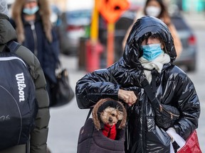 A Montrealer and their dog stroll through the city March 29, 2022.