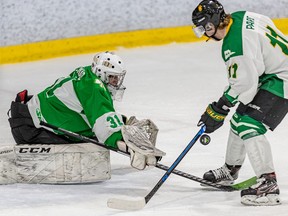 Shamrocks goalie Philippe MacNab successfully pulls off a poke check against Condors Samy Pare during first period action at the Pierrefonds Sportplexe on Saturday.