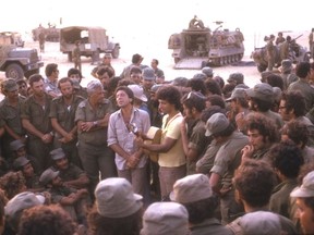 Leonard Cohen performs for Israeli troops in Sinai in October 1973, flanked by future prime minister Ariel Sharon, left, and Israeli musician Matti Caspi.