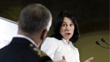 Montreal mayor Valérie Plante speaks to police chief Sylvain Caron during a news conference at the end of the final day of the Montreal forum to fight armed violence, in Montreal on Thursday, March 31, 2022.