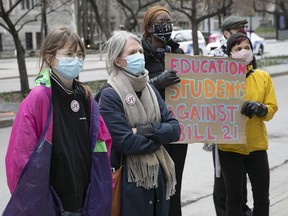 Demonstrators gather outside Premier François Legault's office to protest a court ruling on Bill 21 on April 20, 2021.