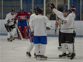 Members of the Pointe-Claire old-timers hockey team celebrate a goal against Montreal Canadiens alumni in a 2019 game.
