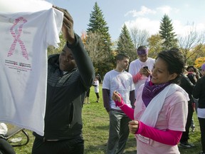 Nalie Agustin, right, is seen in 2014 after inscribing a T-shirt at the annual Run for the Cure event at Parc Maisonneuve in Montreal. Agustin died this week of breast cancer, at age 33.