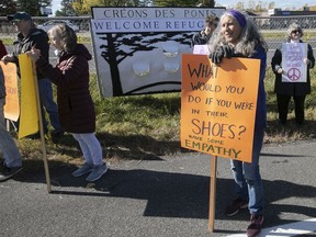 A small group of members of the coalition Creons des ponts - Bridges not Borders, a local refugee support group, take part in protest near the St-Bernard-de-Lacolle border post on Saturday October 19, 2019.