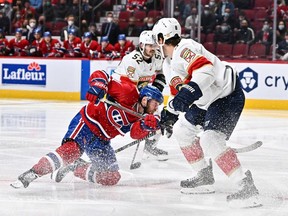 Canadiens' Paul Byron  plays the puck past former teammate Ben Chiarot of the Panthers during the second period at the Bell Centre Thursday night.