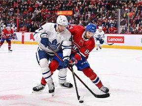 Toronto Maple Leafs' Pierre Engvall  and Canadiens' William Lagesson (84) vie for position to the puck during the first period at the Bell Centre on Saturday, March 26, 2022, in Montreal.