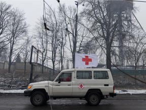 A red cross van drives through rubble in front of the Kyiv TV Tower on March 2, 2022 in Kyiv, Ukraine.