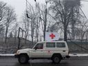 A Red Cross van drives through the rubble in front of the Kyiv TV Tower on March 2, 2022 in Kyiv, Ukraine.