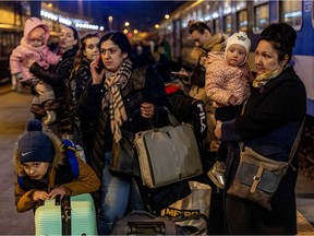 People arrive to the Western Railway Station in Budapest on Thursday. Hundreds of thousands of refugees from Ukraine have fled into neighbouring countries after Russia began a large-scale invasion a week ago.